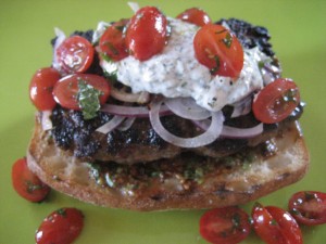 Lamb burger with yogurt cilantro dill sauce and mint tomatoes