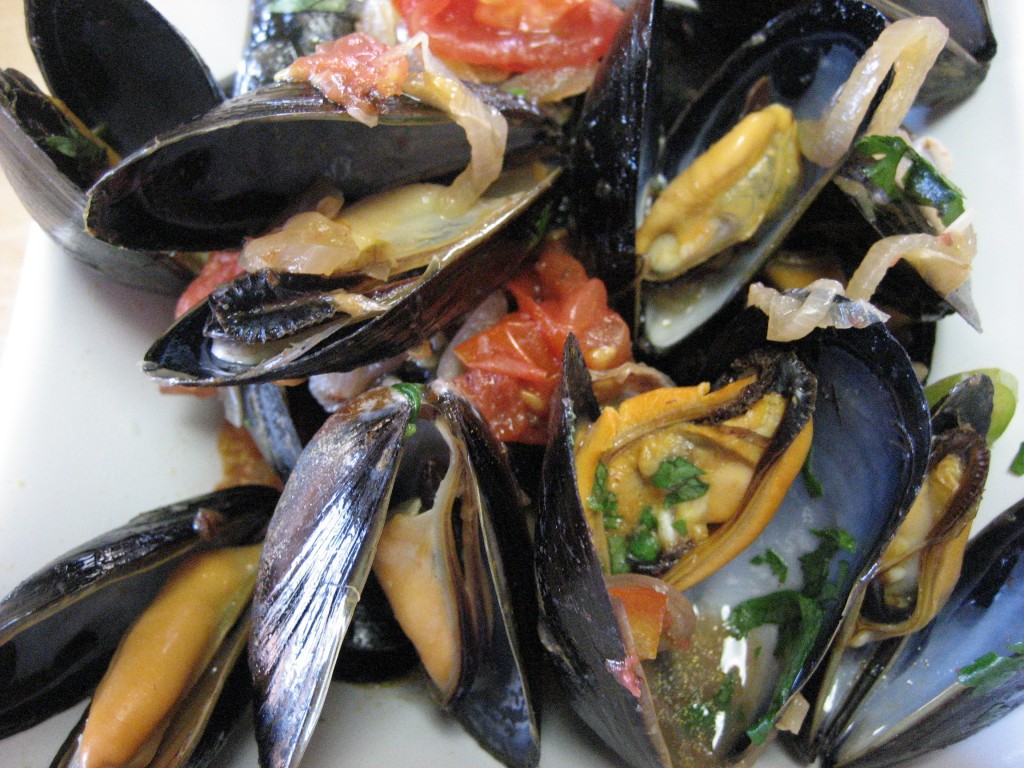 Thai inspired mussels with red chilies, lemongrass, garlic and tomatoes